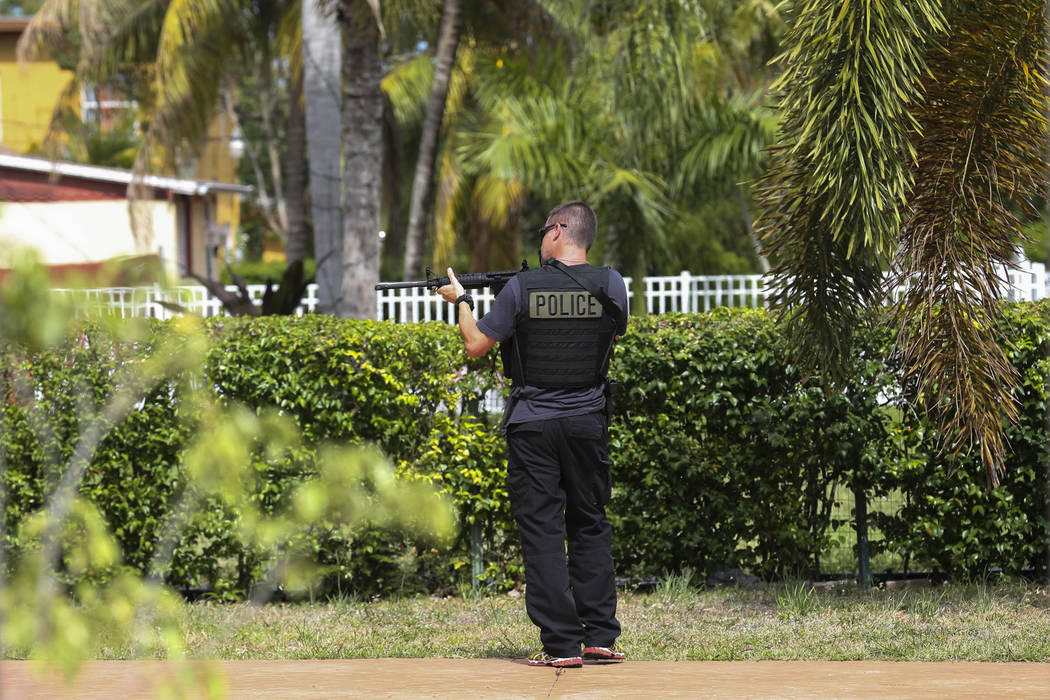 Miami-Dade Police Detective Daniel Garcia conducts an operation to remove squatters from a house in Miami on Tuesday, April 18, 2017. Matias J. Ocner