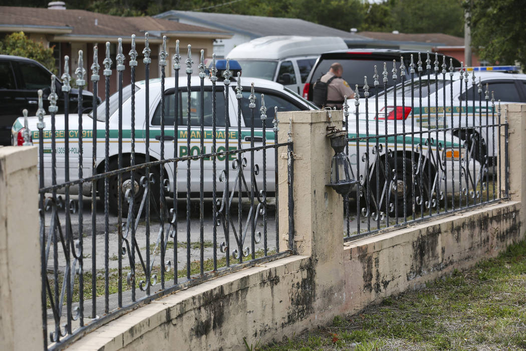 A broken light fixture is seen the entrance of a suspected squatter house in Miami on Tuesday, April 18, 2017. Matias J. Ocner