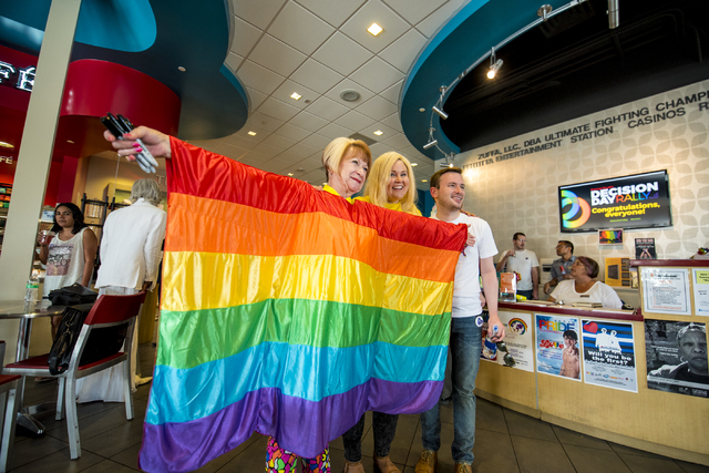 Arlene Cooper, from left, Cristina DiGioia, and Sean VanGorder, pose for a photo during the Decision Day Rally at The Gay & Lesbian Community Center of Southern Nevada in Las Vegas on Friday,  ...
