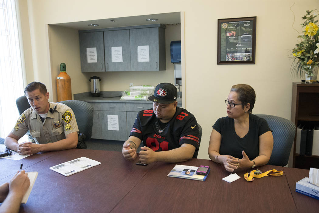 Las Vegas police Sgt. Dave Watts, from left, with Jose Guzman, and his mother Edith, during an interview on her other son Jose De Jesus Alatorre Guzman who was killed last year at the age of 19 wh ...