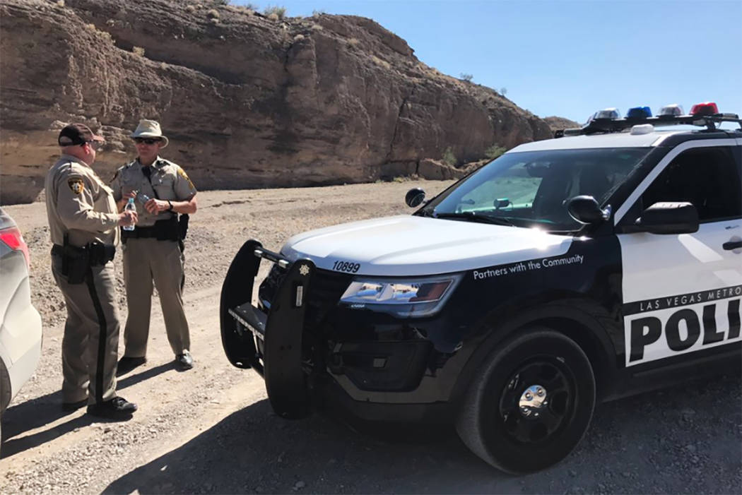 Two Metro officers block an entrance to Eagle Wash Road, the direction where remains were found encased in cement near Lake Mead National Recreation Area on Tuesday, May 2, 2017. (Bridget Bennett/ ...