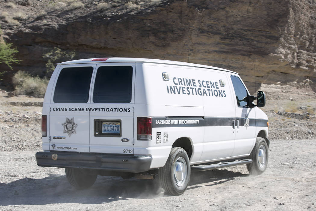 A Las Vegas Metropolitan Crime Scene Investigations van arrives at an entrance to Eagle Wash Road, that leads to the crime scene, at Lake Mead National Recreation Area on Tuesday, May 2, 2017. Bri ...