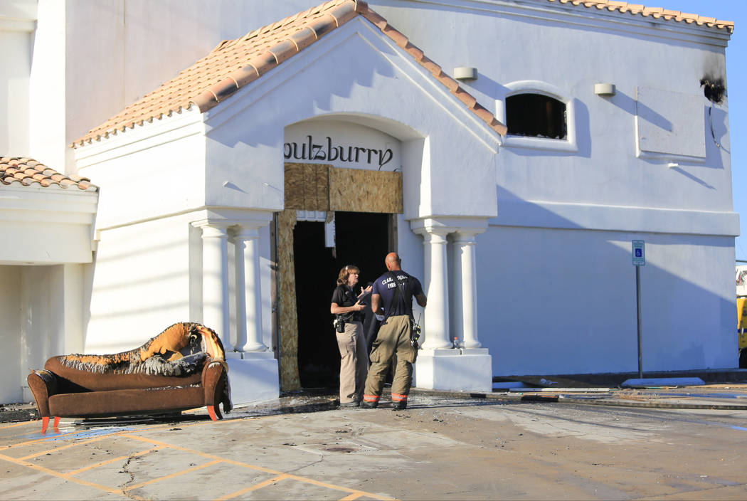 Clark County firefighters clean up the scene of a two-alarm fire at 5285 Dean Martin Drive, near the Las Vegas Strip, on Thursday, May 4, 2017. Brett Le Blanc Las Vegas Review-Journal @bleblancphoto