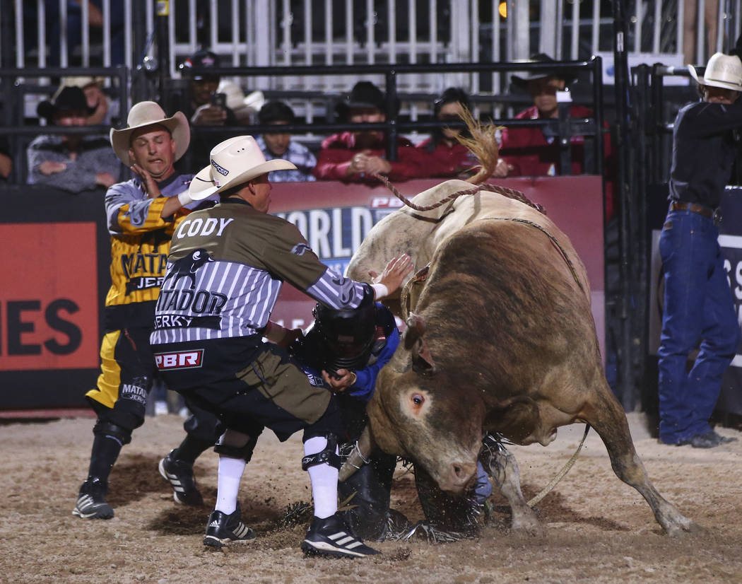 Professional Bull Riders bullfighters, from left, Cody Webster, Seth  "Shorty" Gorham and Frank Newsom prepare for the Last Cowboy  Standing event at Las Vegas Village in Las Vegas …