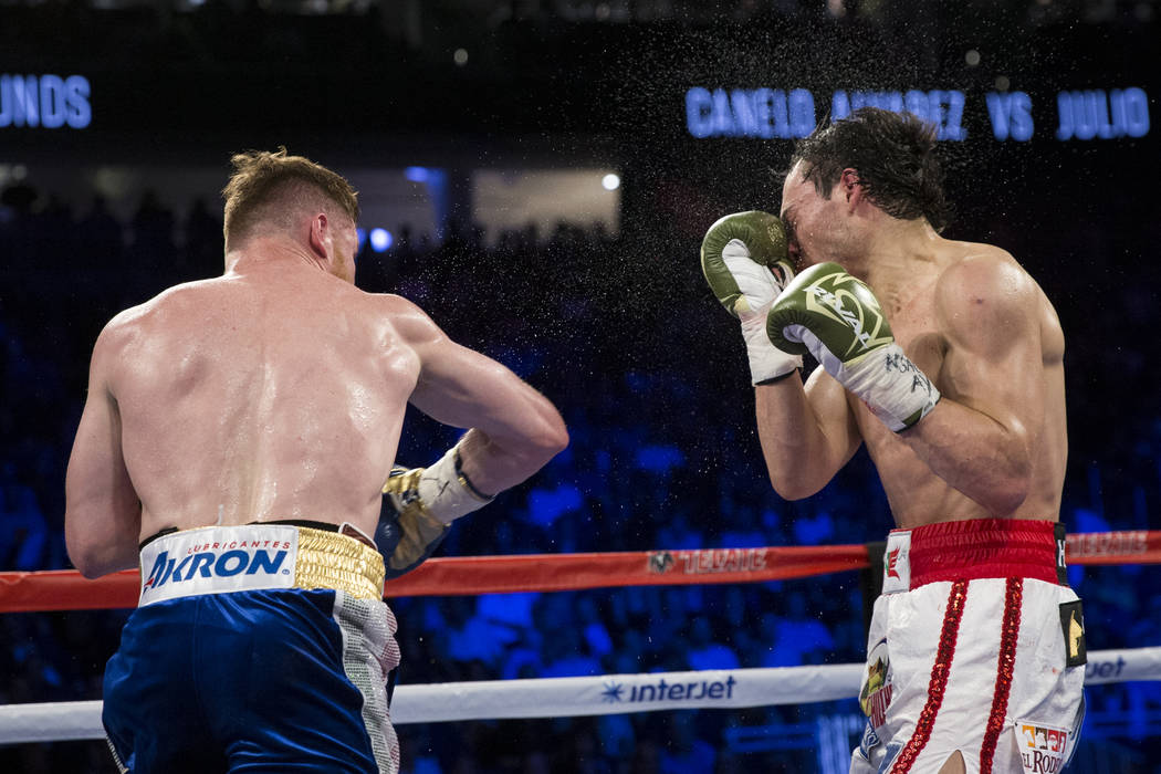 Saul Canelo Alvarez, left, connects a punch against Julio Cesar Chavez Jr. in the catch weight bout at T-Mobile Arena on Saturday, May 6, 2017, in Las Vegas. Alvarez won by unanimous decision. Eri ...