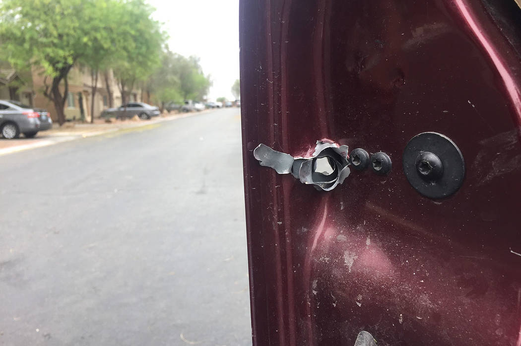 A bullet hole is seen Sunday in the front door of a truck on Shreve Avenue in Las Vegas. (Blake Apgar/Las Vegas Review-Journal)