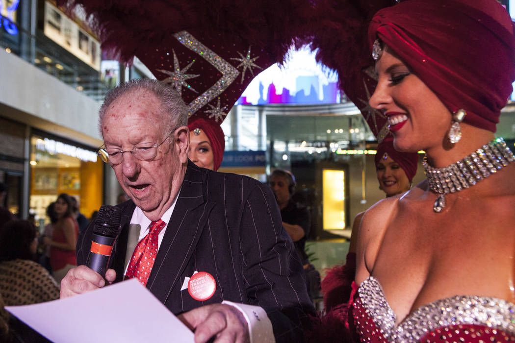 Former Las Vegas Mayor Oscar Goodman hands out prizes to the crowd with the help of a few Viva Las Vegas Showgirls during a celebration of tourism hosted by the Las Vegas Convention and Visitors A ...