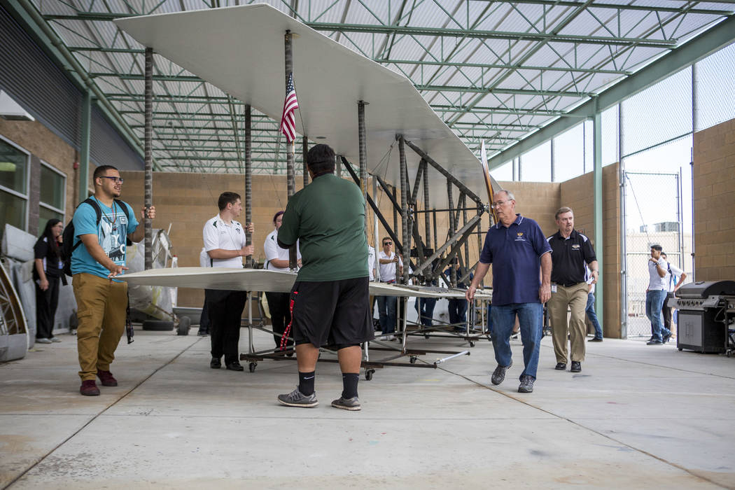 Aviation students and instructors transport the wings of a full-size replica of the 1905 Wright Brothers Flyer at Rancho High School in Las Vegas on Monday, May 15, 2017. The model, originally des ...