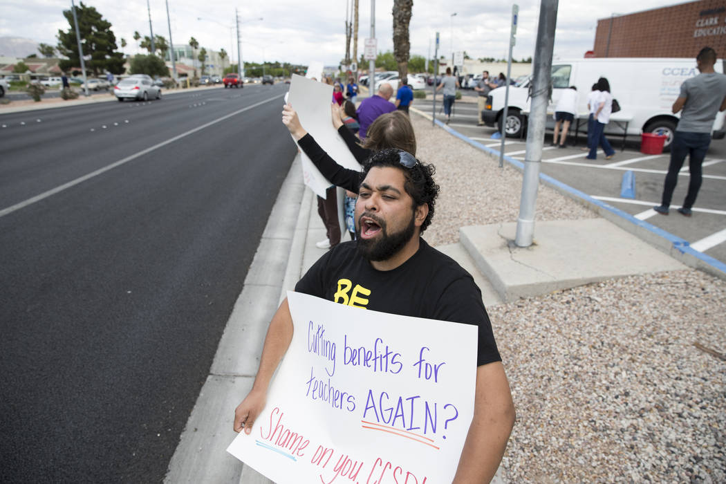 Middle school teacher Mario Wolthers attends a rally for affordable health insurance with other teachers and supporters outside of the Clark County School District Education Center before a board  ...