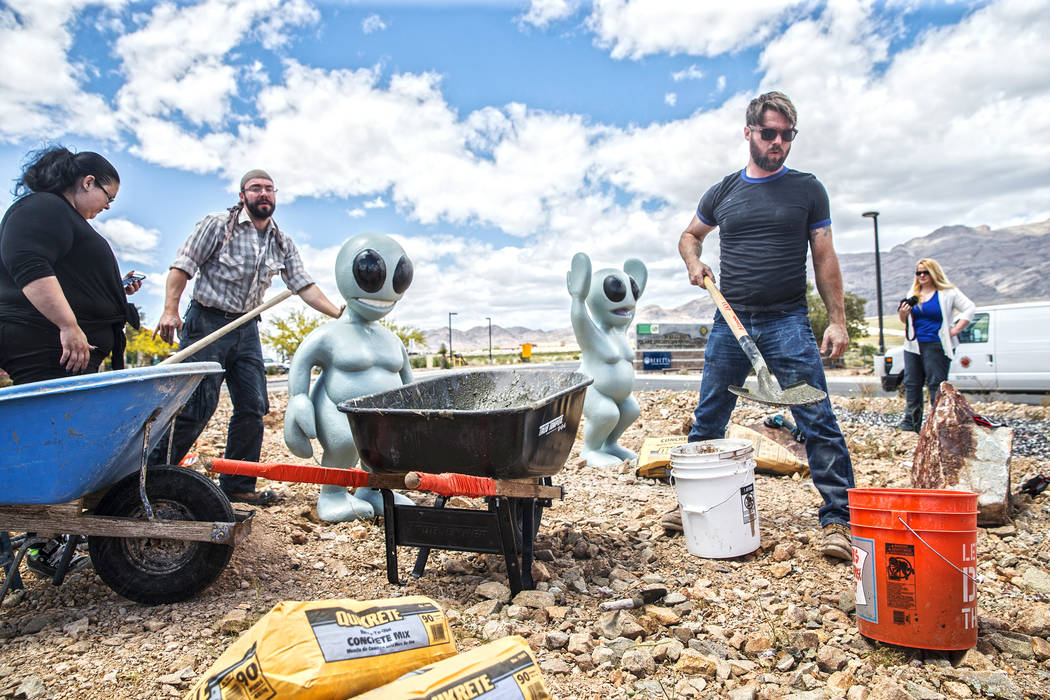 Gia Ray, left, artist Jesse Smigel and James Norman work on the installation of Smigel's sculpture &quot;I Told You Not to Paint It Hot Orange&quot; on Thursday, May 18, 2017, in Las Vegas ...
