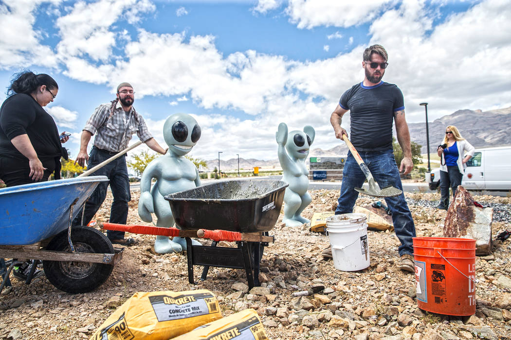 Gia Ray, left, artist Jesse Smigel and James Norman work on the installation of Smigel's sculpture "I Told You Not to Paint It Hot Orange" on Thursday, May 18, 2017, in Las Vegas ...