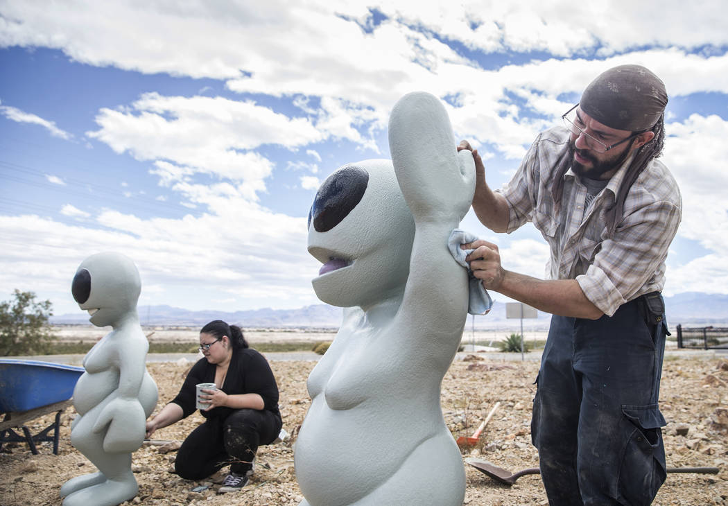 Artist Jesse Smigel, right, and Gia Ray work on the installation of Smigel's sculpture &quot;I Told You Not to Paint It Hot Orange&quot; on Thursday, May 18, 2017, in Las Vegas. Benjamin H ...