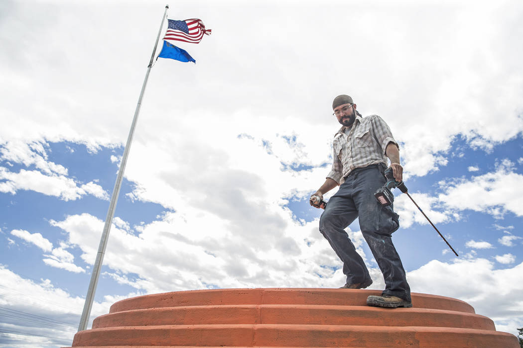 Artist Jesse Smigel works on the installation of his sculpture "I Told You Not to Paint It Hot Orange" on Thursday, May 18, 2017, in Las Vegas. Benjamin Hager Las Vegas Review-Journal @benjaminhphoto