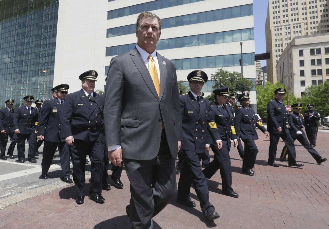 Dallas Mayor Mike Rawlings helps lead a march by police officers during a memorial service in downtown Dallas, Wednesday, May 17, 2017. The Dallas Police Department and city leaders held a ceremon ...