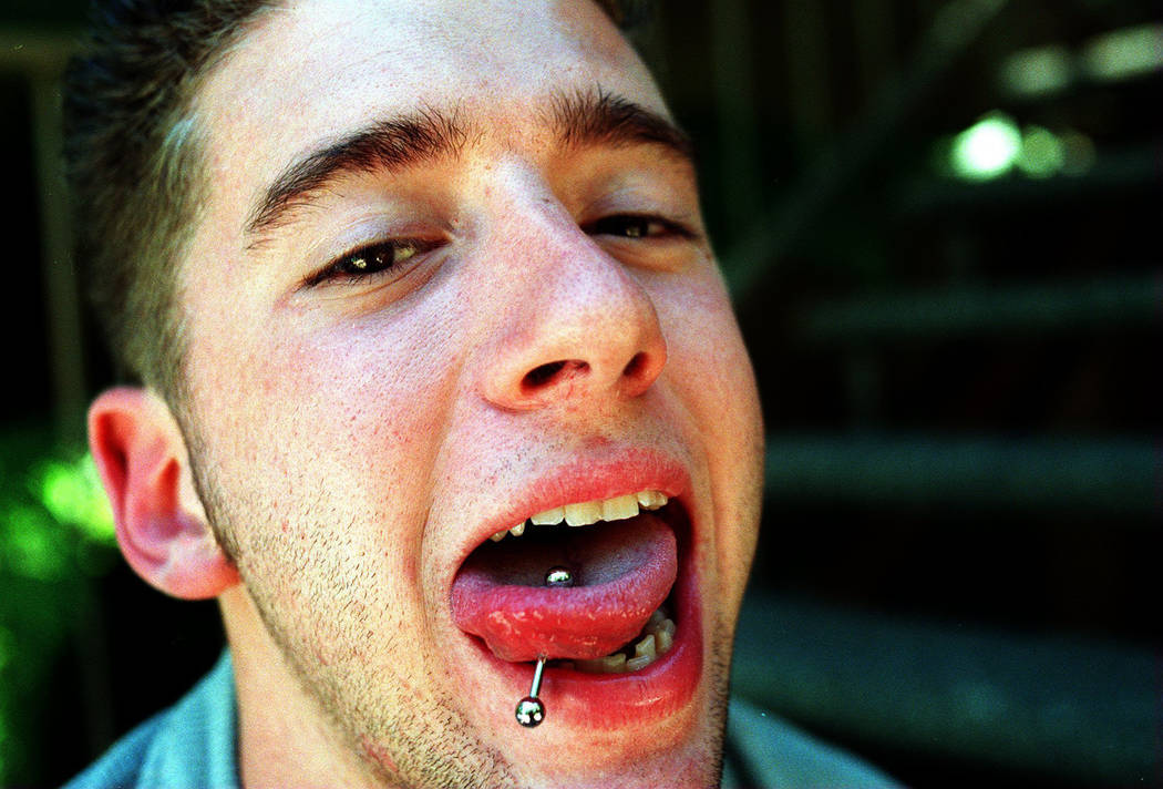 Eighteen-year-old David Cash Jr. of La Palma, California, shows his pierced tongue as he sits on the steps of his home May 29, 1997. Cash was with his best friend, Jeremy Strohmeyer, at the Primad ...