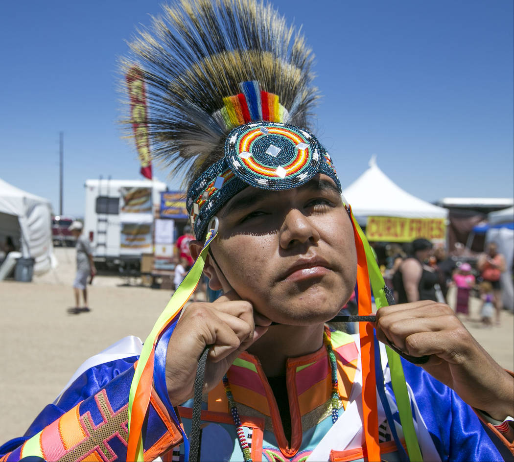 Cason Deschine, 15, of Cedar City, Utah, adjust his headpiece before participating in the grand entry ceremonies during the 28th annual Snow Mountain Pow Wow on Saturday, May 27, 2017. Richard Bri ...