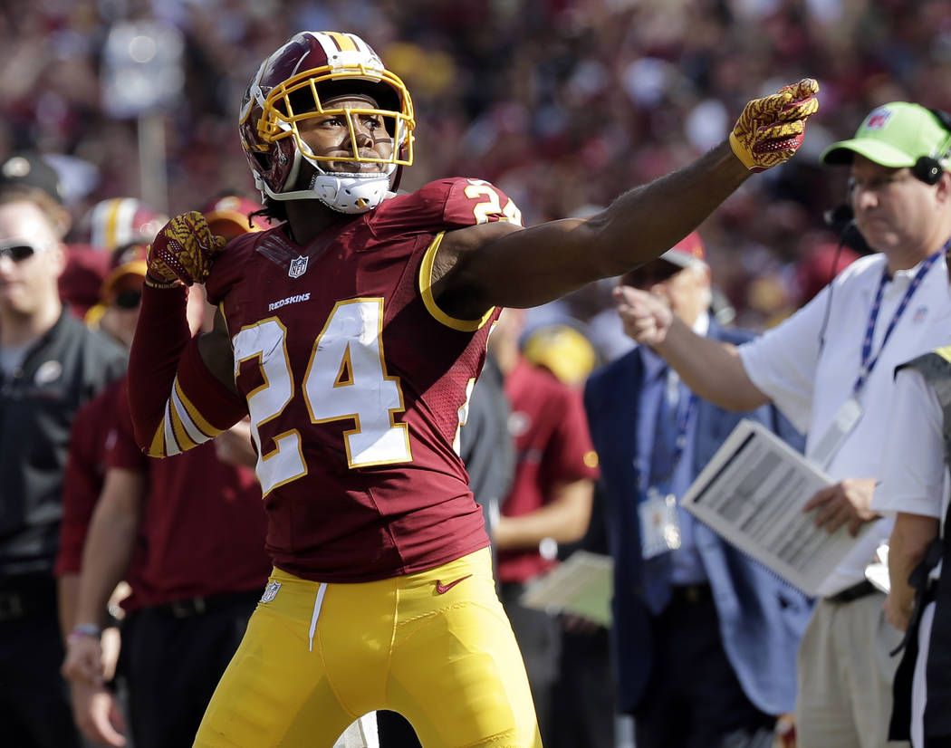 FILE - In this Oct. 2, 2016, file photo, Washington Redskins cornerback Josh Norman (24) celebrates his interception with a "bow and arrow," gesture during the second half of an ...