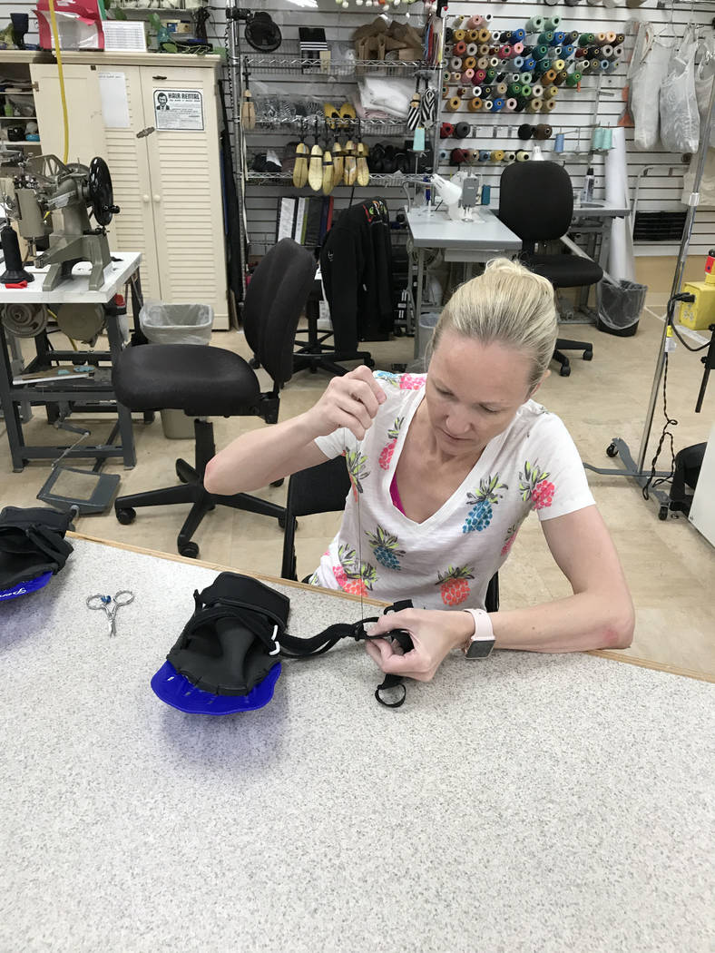 Brynn Coseru, a Cirque du Soleil synchronized swimmer, creates the hand fins she made as part of the requirements for her master's degree in occupational therapy degree at Touro University. 
Photo ...