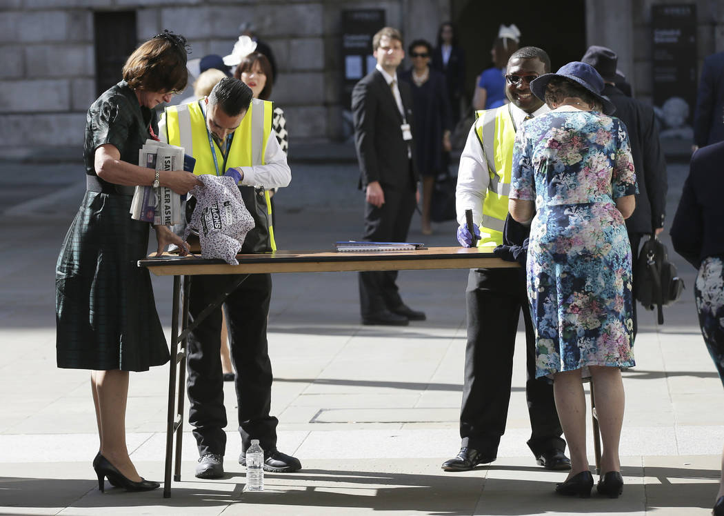 People have their bags searched outside St Paul's Cathedral in London, Wednesday May 24, 2017 ahead of a service to mark the one hundredth anniversary of the Order of the British Empire. Britons w ...
