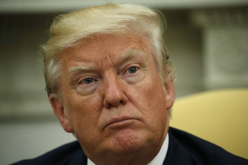 U.S. President Donald Trump listens to questions from the media as he meets with Colombia's President Juan Manuel Santos (not pictured) in the Oval Office in Washington, DC, U.S., May 18, 2017. RE ...