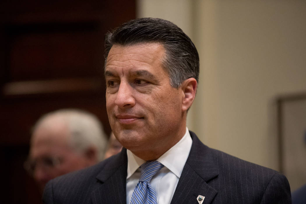 Nevada Gov. Brian Sandoval waits for President Donald Trump to arrive for a federalism event with governors in the Roosevelt Room at the White House in Washington, Wednesday, April 26, 2017. (AP P ...
