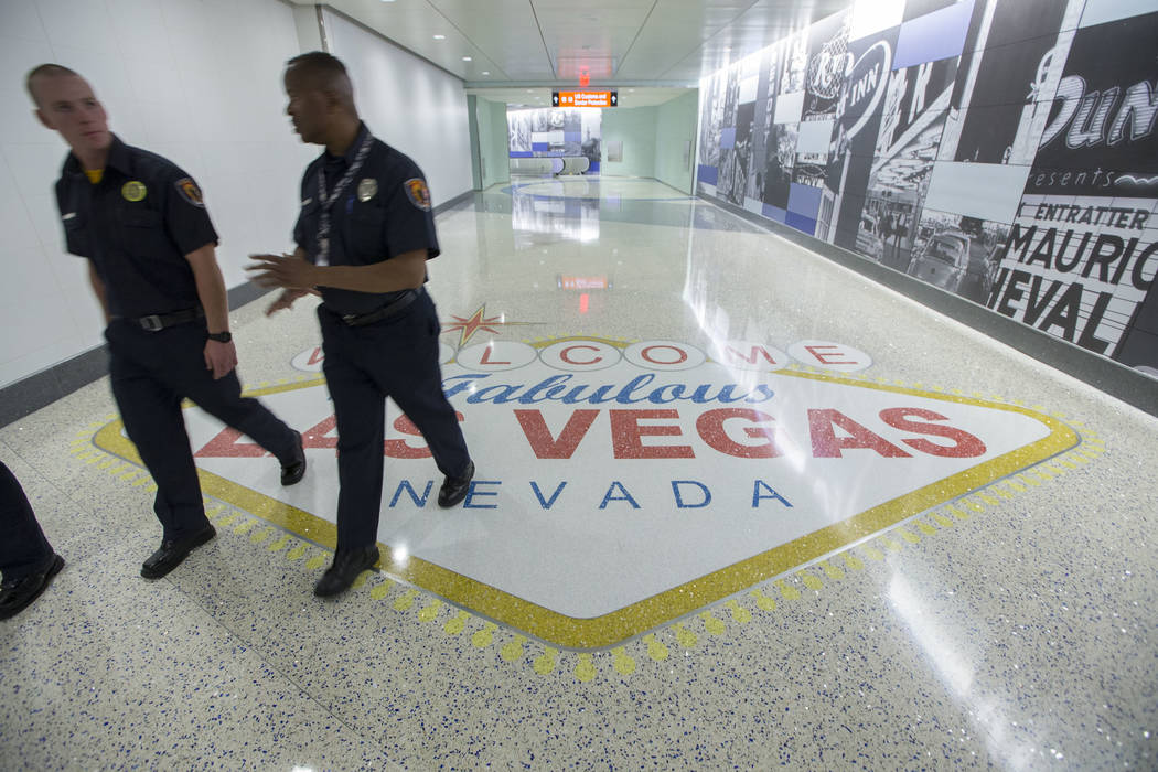 Clark County firefighters walk through the recently completed 995-foot-long corridor linking the D-Gate Concourse to the airport’s U.S. Customs and Border Protection station in Terminal 3 a ...