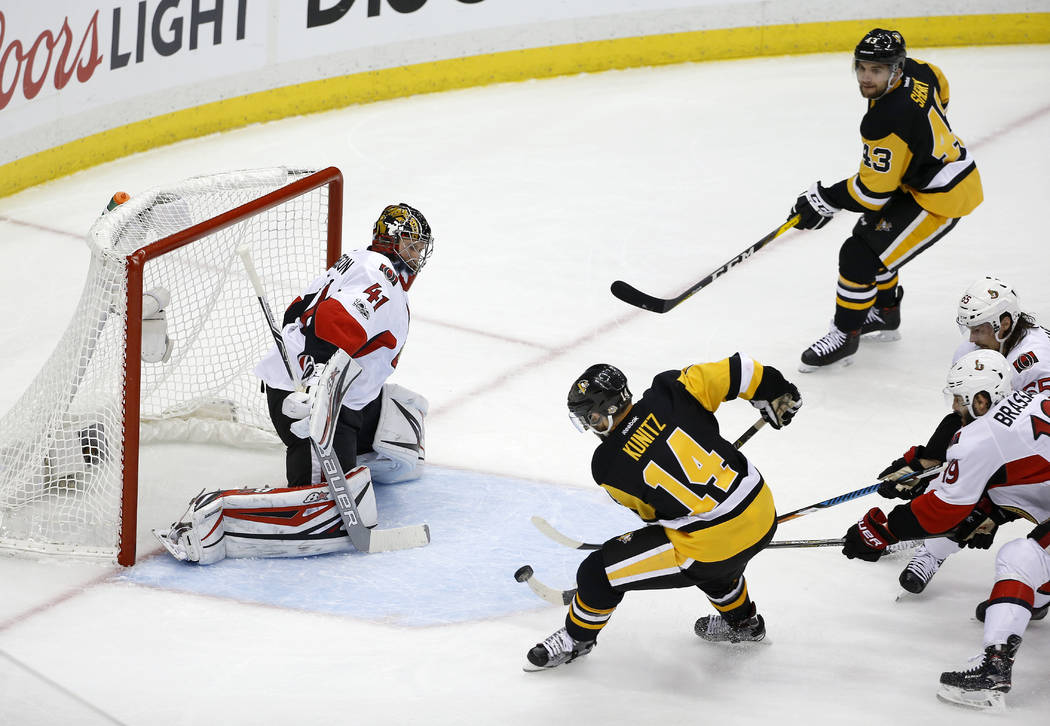 Pittsburgh Penguins left wing Chris Kunitz (14) scores a goal against Ottawa Senators goalie Craig Anderson (41) during the second period of Game 7 of the Eastern Conference final in the NHL Stanl ...