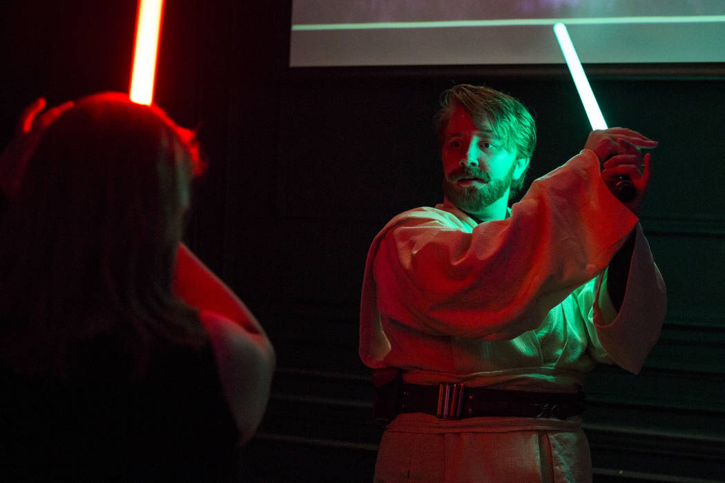 Amanda Bond, left, and Rebecca Zobell, dressed as Obi Wan Kenobi, practice their lightsaber skills as they celebrate the 40th anniversary of the release of Episode IV РA New Hope at the Mill ...