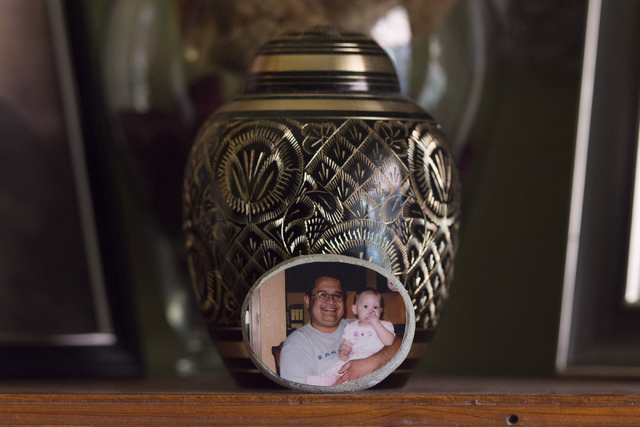 An urn holding Mark Santee's ashes sits on a shelf at his daughter Amber Santee's residence in Henderson Monday, Aug. 15, 2016. Mark Santee was randomly killed while working as a security guard at ...
