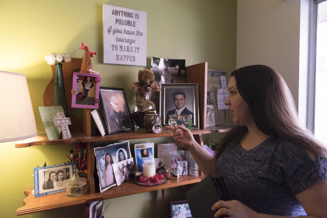 Amber Santee shows family photos at her residence in Henderson, Monday, Aug. 15, 2016. Santee's father, Mark, was randomly killed while working as a security guard at a southwest valley constructi ...