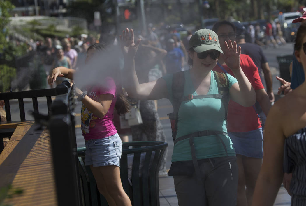 Pedestrians cool off on water misters along Las Vegas Boulevard in Las Vegas on Thursday, May 25, 2017. Richard Brian Las Vegas Review-Journal @vegasphotograph