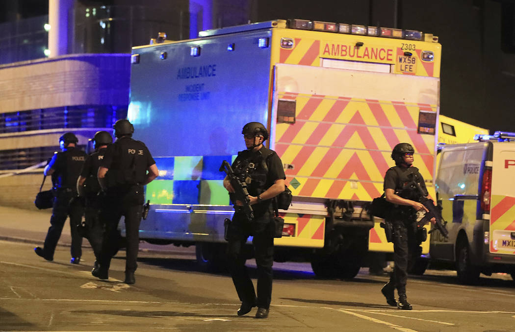 Armed police work at Manchester Arena after reports of an explosion at the venue during an Ariana Grande gig in Manchester, England Monday, May 22, 2017. Several people have died following reports ...