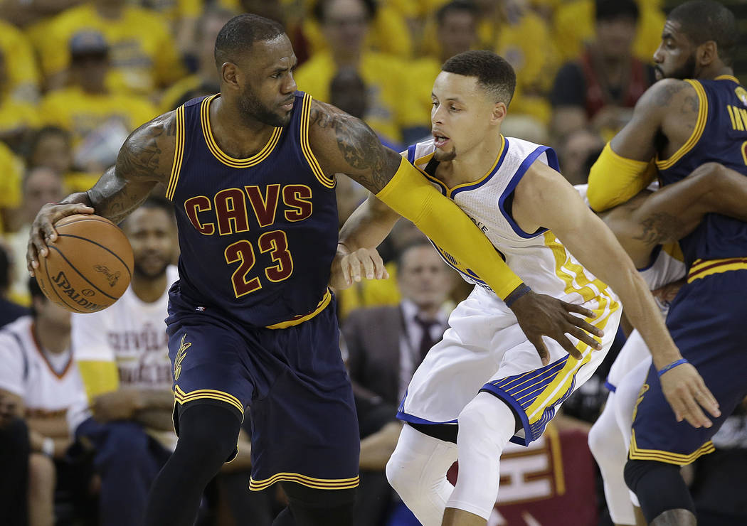 FILE - In this June 2, 2016, file photo, Cleveland Cavaliers forward LeBron James (23) dribbles against Golden State Warriors guard Stephen Curry during the first half of Game 1 of basketball's NB ...