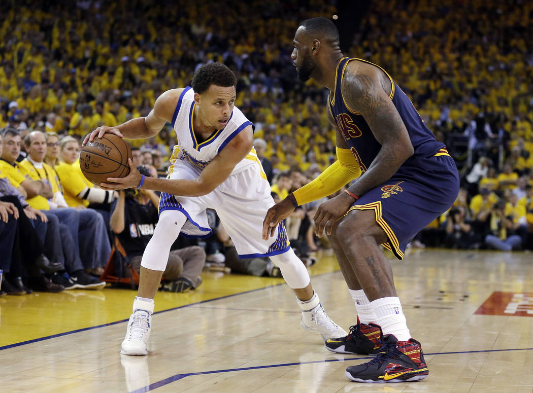 FILE - In this June 14, 2015, file photo, Golden State Warriors guard Stephen Curry, left, is guarded by Cleveland Cavaliers forward LeBron James during the second half of Game 5 of basketball's N ...