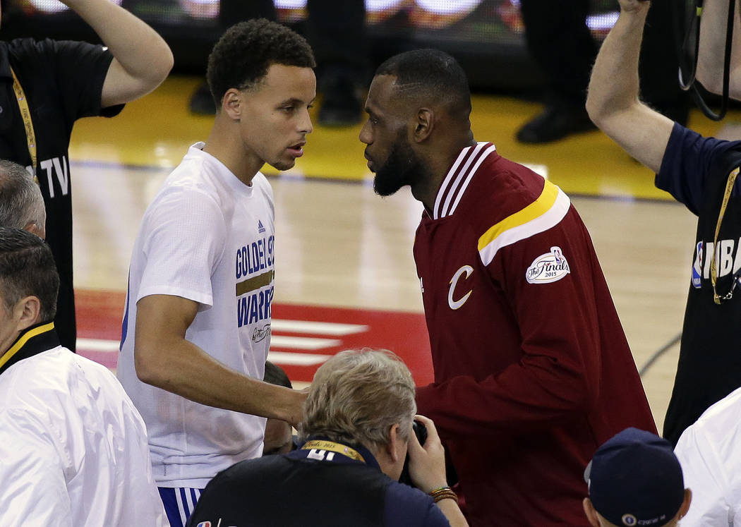 FILE - In this June 14, 2015, file photo, Golden State Warriors guard Stephen Curry, left, shakes hands with Cleveland Cavaliers forward LeBron James before Game 5 of basketball's NBA Finals in Oa ...