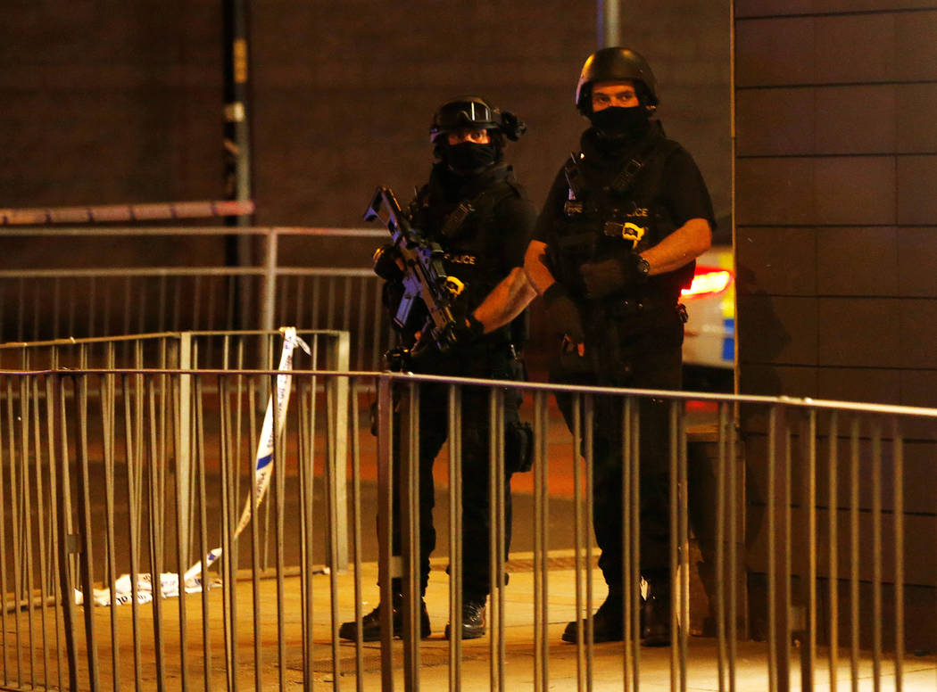 Armed police officers stand next to a police cordon outside the Manchester Arena, where U.S. singer Ariana Grande had been performing, in Manchester, northern England, Britain, May 23, 2017. REUTE ...