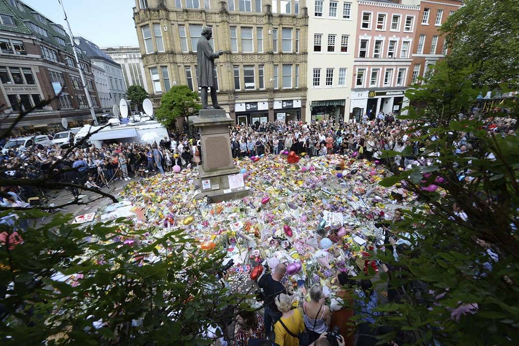 People hold a minute of silence in a square in central Manchester, England, Thursday, May 25, 2017, for the victims of the suicide attack on Monday night. (Ben Birchall/PA via AP)