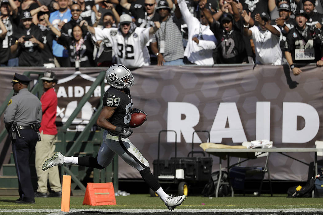 Oakland Raiders wide receiver Amari Cooper (89) scores on a touchdown reception during the second half of an NFL football game against the San Diego Chargers in Oakland, Calif., Sunday, Oct. 9, 20 ...