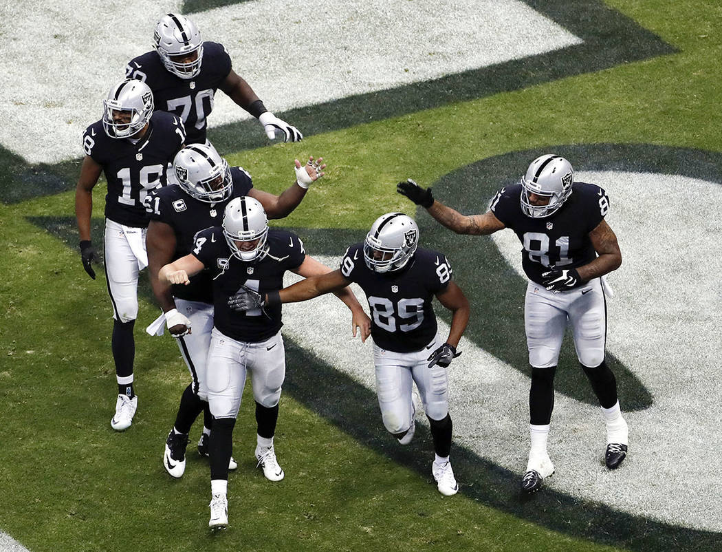 Oakland Raiders wide receiver Amari Cooper (89) celebrates his touchdown with teammates during the second half of an NFL football game against the Houston Texans Monday, Nov. 21, 2016, in Mexico C ...
