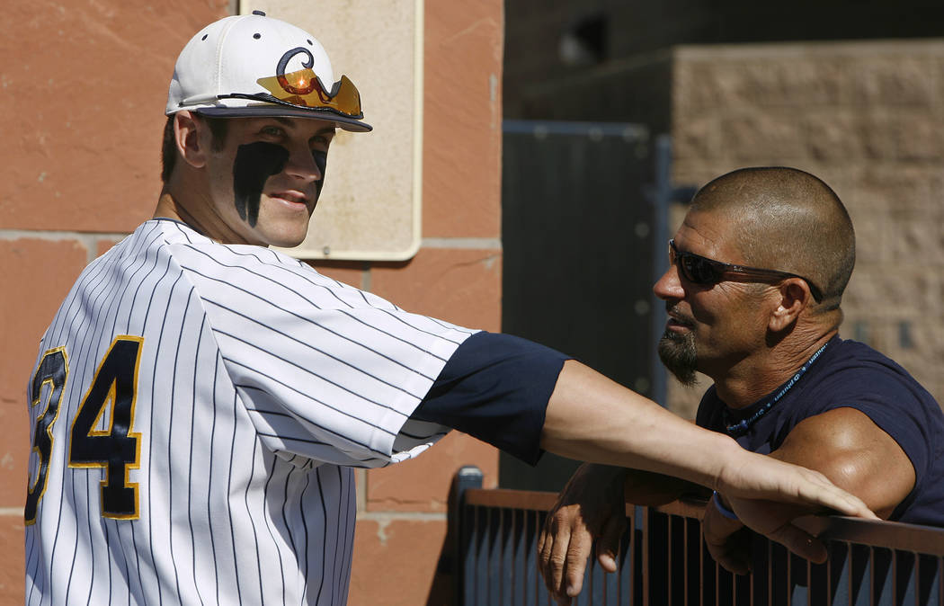 In this April 30, 2010, file photo, College of Southern Nevada baseball player Bryce Harper, left, talks with his father Ron Harper during a college baseball game in Henderson, Nev.  (AP Photo/Isa ...
