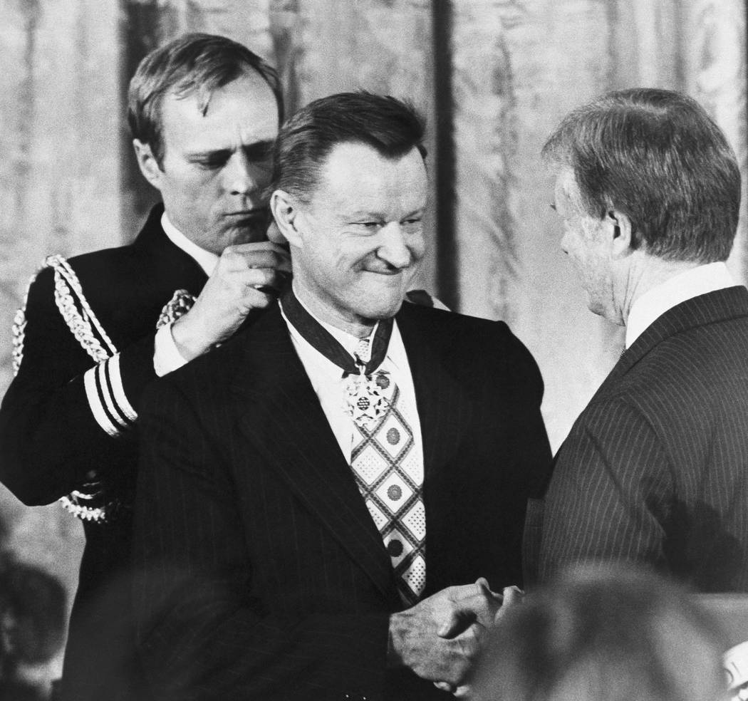 FILE - In this Jan. 17, 1981 file photo, President Jimmy Carter shakes hands with his national security adviser, Zbigniew Brzezinski, as he presents Brzezinski with the Medal of Freedom at a White ...