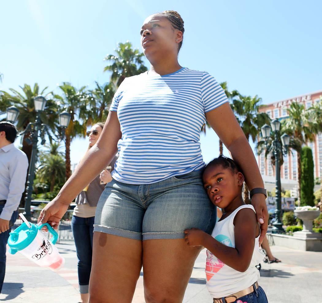 Tourist Sharonta Phianzee and her daughter Peyton, 3, stand in unity with protesters in front of The Venetian to protest the police involved death of Tashii Brown in Las Vegas, Sunday, May 28, 201 ...