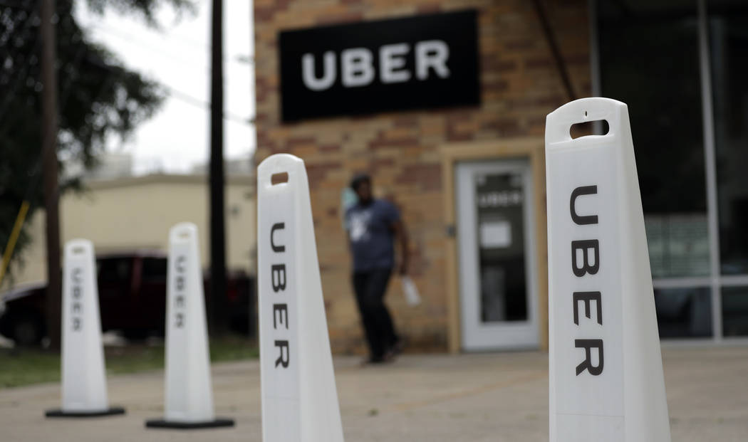 In this Friday, May 26, 2017 photo, a man exits the Uber offices in Austin, Texas.  (AP Photo/Eric Gay, file)