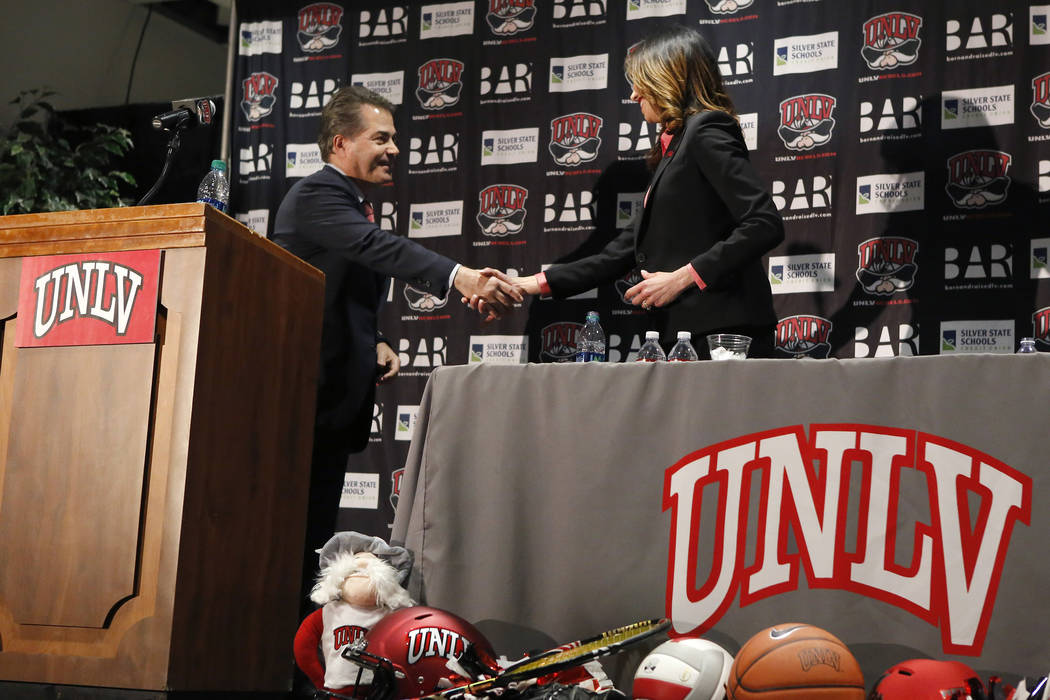 UNLV's President Len Jessup, from left, and Desiree Reed-Francois shakes hands at the Thomas & Mack Center during a press conference where Reed-Francois was announced as the university's new a ...
