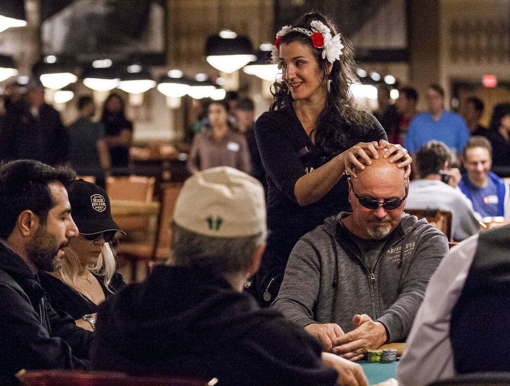 A man gets a massage while playing poker during the opening of the World Series of Poker at the Rio Convention Center on Wednesday, May 31, 2017. Patrick Connolly Las Vegas Review-Journal @PConnPie