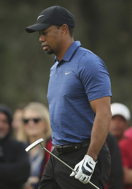 In this Thursday, Feb. 2, 2017 photo, Tiger Woods prepares for a shot on hole 10th during the 1st round of the Dubai Desert Classic golf tournament in Dubai, United Arab Emirates. Tiger Woods has ...