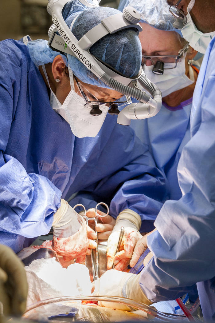 Dr. Quynh Feikes performs a surgery to fix an abdominal aneurysm with help from assistant Tracy Blankenship, center, and Dr. Deepak Malhotra at University Medical Center on Tuesday, May 23, 2017.  ...