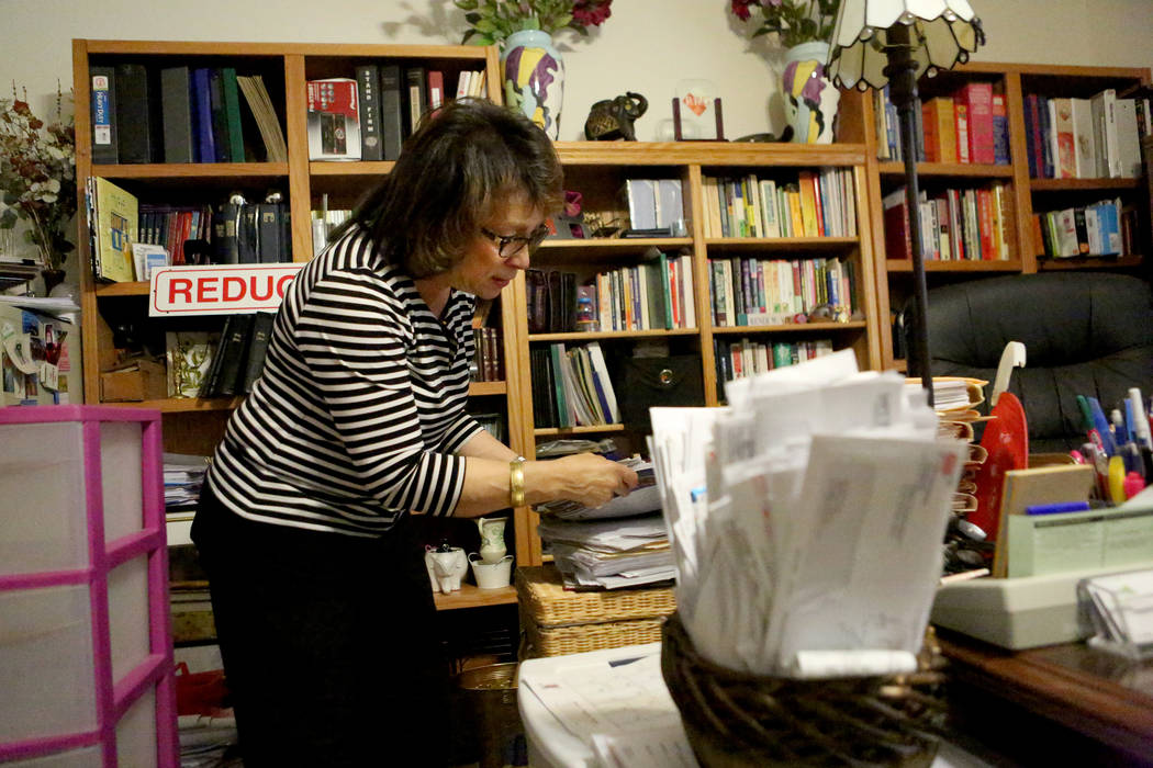 At her home on May 25, foster parent Renee Viray shuffles through some of the paperwork she is required to keep for the foster children that are in her care. Michael Quine/Las Vegas Review-Journal ...