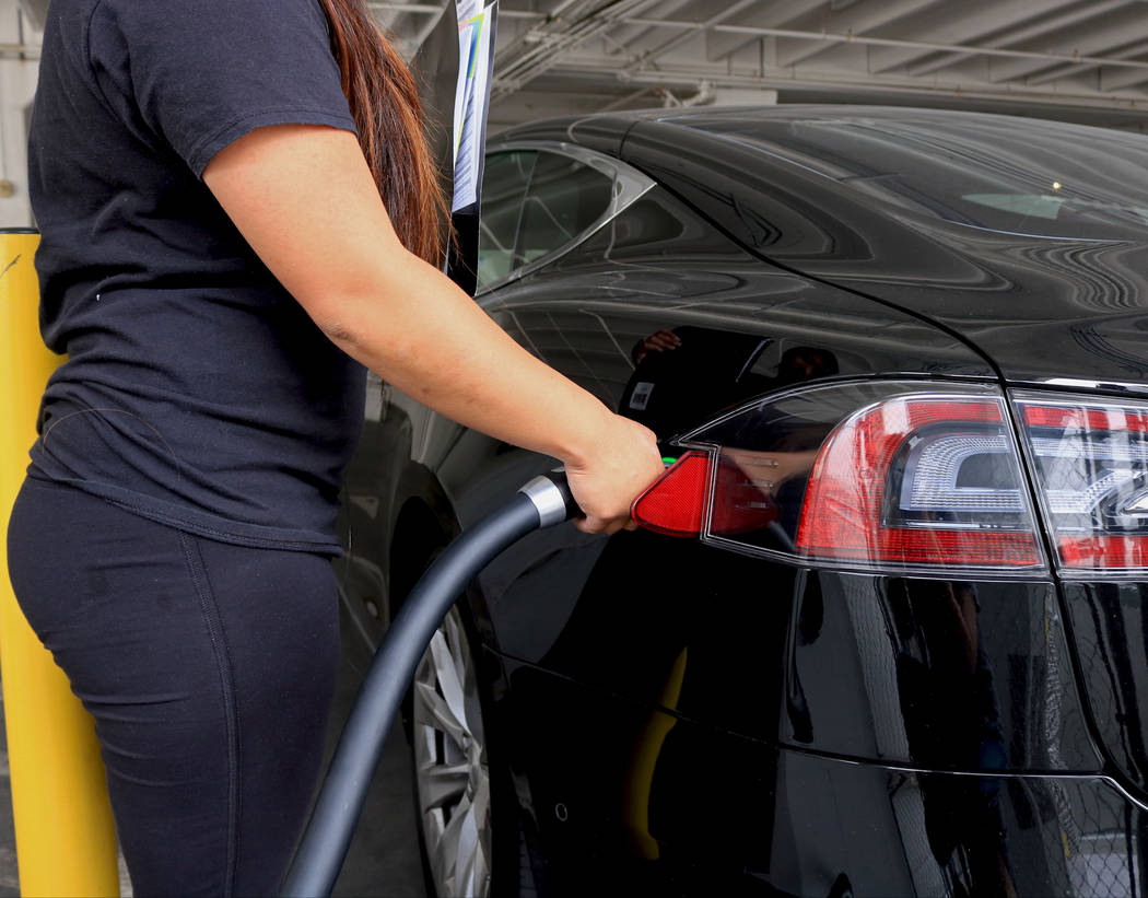 A woman charges her car at an EV charging station on East Bridger Avenue, Wednesday, May 31, 2017. Gabriella Benavidez Las Vegas Review-Journal @latina_ish