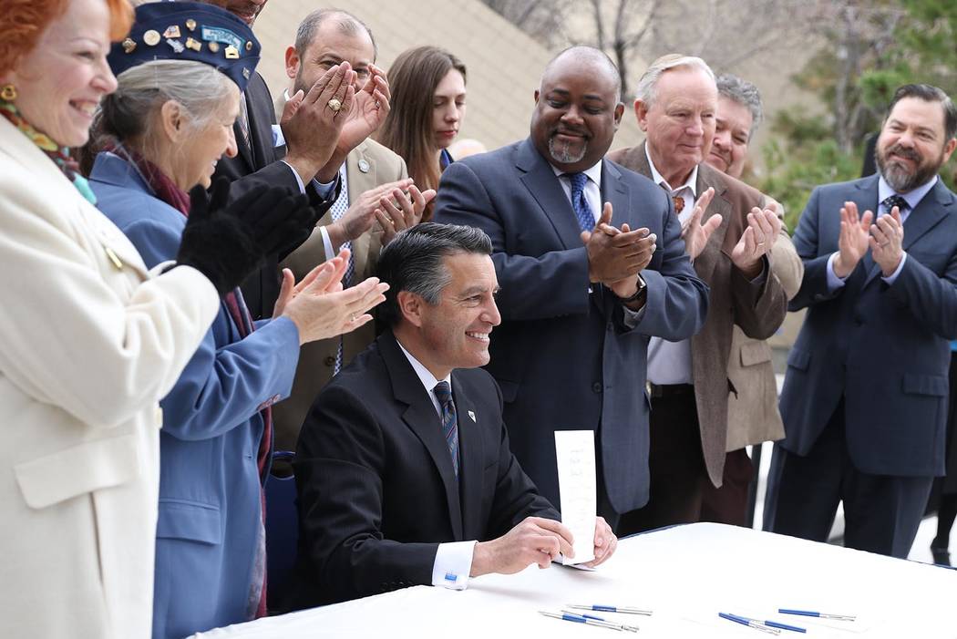 Photo provided by Nevada Governor's Office Nevada Gov. Brian Sandoval signed three bills related to veterans services at a ceremony on the Capitol grounds in Carson City in March.